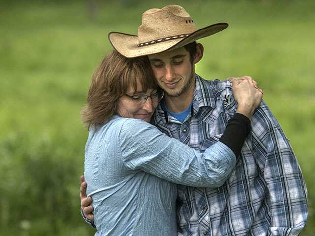 Mother and son embracing in a field