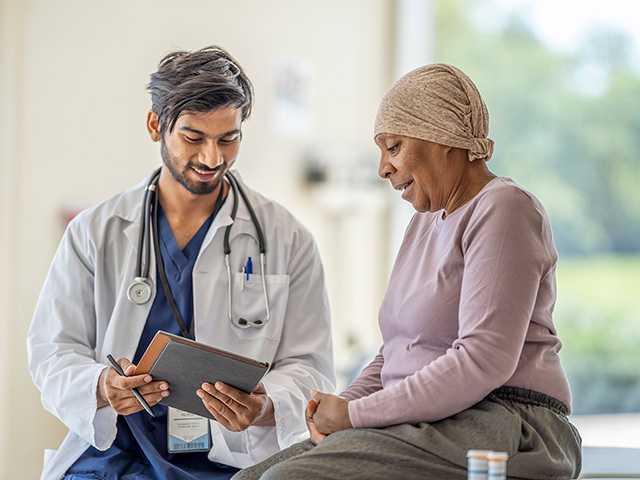 Woman in scarf talking to provider