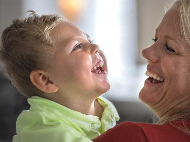 Woman and baby smiling.